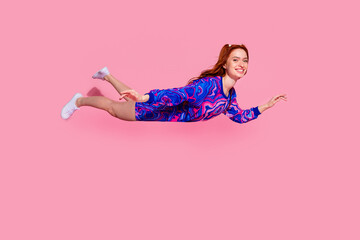 Poster - Full body photo of attractive young woman flying air dressed stylish blue print clothes isolated on pink color background