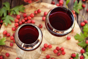 Poster - Two glass cups of medicinal wine prepared from fresh hawthorn berries