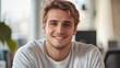 © Johannes - Portrait of attractive smiling man sitting in office and looking at camera..
