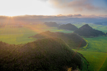 The magnificent view of the flower field from the hill top in Luoping, Yunnan during the sunset, dramatic sky with copy space for text