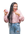 © Krakenimages.com - Young african american girl eating pink donut over isolated background very happy pointing with hand and finger