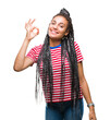 © Krakenimages.com - Young braided hair african american girl over isolated background smiling positive doing ok sign with hand and fingers. Successful expression.
