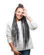 © Krakenimages.com - Young braided hair african american girl wearing sweater over isolated background doing ok gesture with hand smiling, eye looking through fingers with happy face.