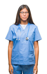 Wall Mural - Young asian doctor woman over isolated background with serious expression on face. Simple and natural looking at the camera.