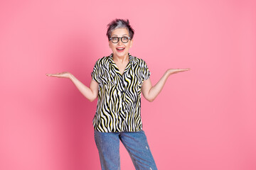 Poster - Photo of nice aged woman hold vs empty space wear zebra print shirt isolated on pink color background