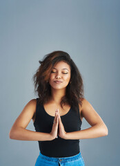 Poster - Happy woman, meditation and zen with namaste for awareness or mindfulness on a gray studio background. Female person, yogi or young model with eyes closed or hands together for inner peace on space