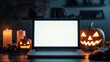 © Synthetica - A laptop is on a table with three pumpkins and candles