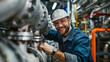 © MikeLegend - Smiling engineer working on industrial machinery in factory.