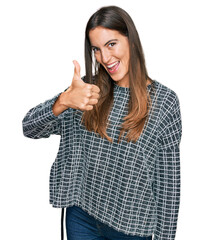 Young beautiful woman wearing casual clothes doing happy thumbs up gesture with hand. approving expression looking at the camera showing success.