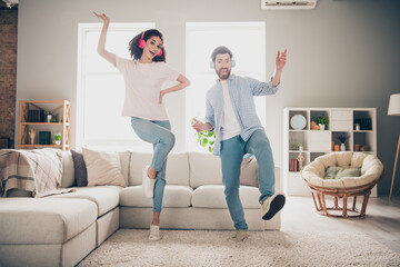 Wall Mural - Full size photo of two nice young partners dancing headphones weekend modern apartment indoors