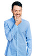 © Krakenimages.com - Hispanic man with beard wearing casual business shirt looking confident at the camera smiling with crossed arms and hand raised on chin. thinking positive.