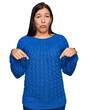 © Krakenimages.com - Young hispanic woman wearing casual clothes pointing down looking sad and upset, indicating direction with fingers, unhappy and depressed.