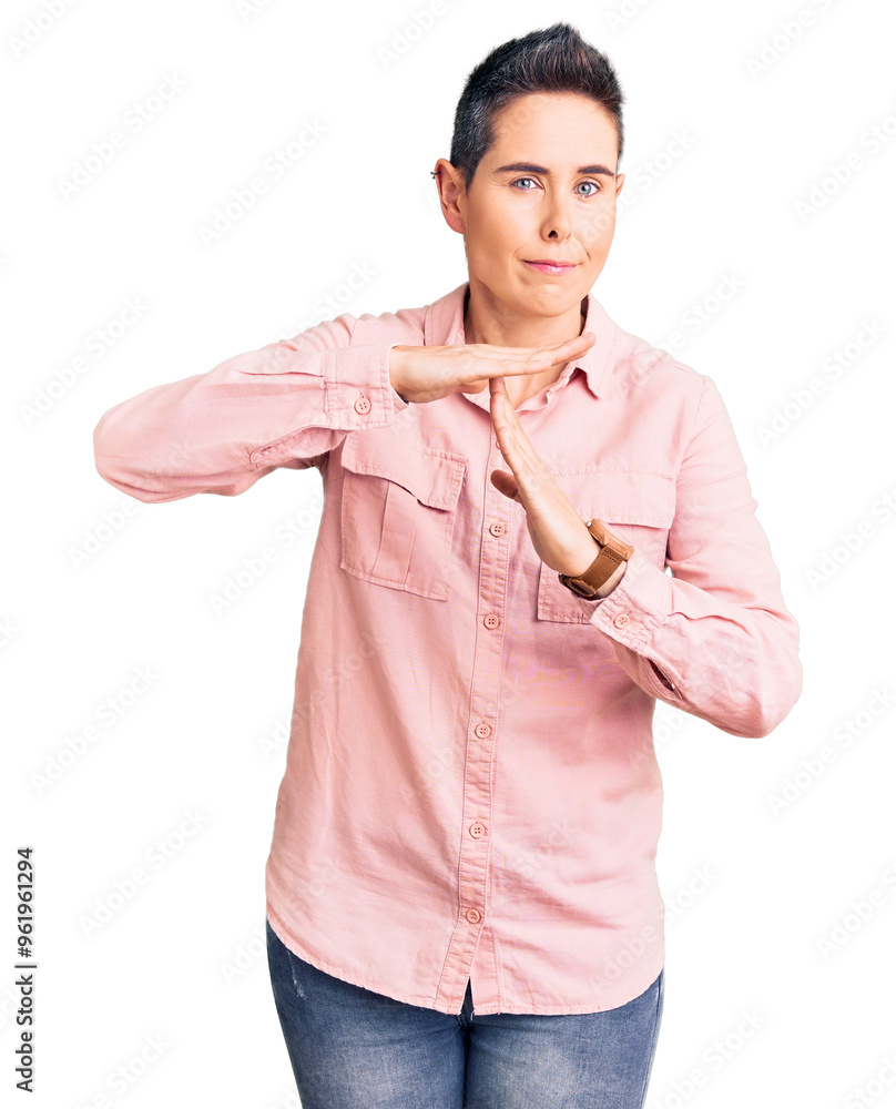 Young woman with short hair wearing casual clothes doing time out gesture with hands, frustrated and serious face