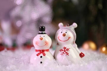 Wall Mural - Funny snowmen figures on artificial snow, closeup