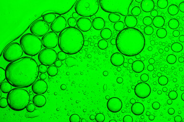 Green macro science bubble texture,green oil drops on a water surface abstract background,Abstract background of soap bubbles on gradient background