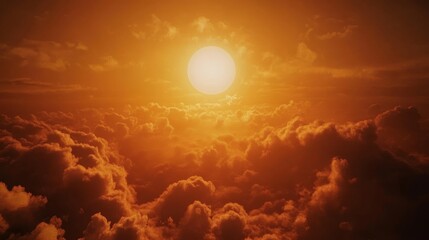 Wall Mural - A beautiful sun rising between clouds in a close-up of warm tones. Sun partially obscured by clouds in a natural landscape.