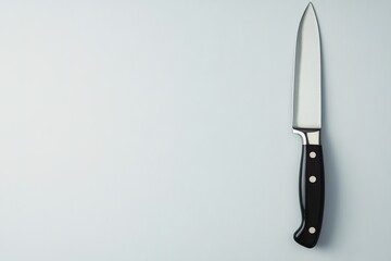 Sharp chef's knife with black handle on light background