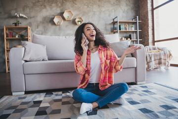 Wall Mural - Photo of excited good mood woman dressed orange shirt talking modern gadget indoors house apartment room