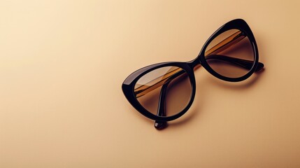 Stylish cat-eye sunglasses displayed on beige background for women's fashion with copy space.