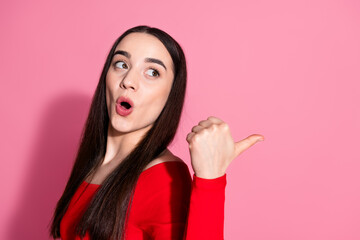 Sticker - Portrait of pretty young woman look indicate finger empty space red shirt isolated on pink color background