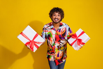 Poster - Photo portrait of attractive young man hold gifts dressed stylish colorful clothes isolated on yellow color background