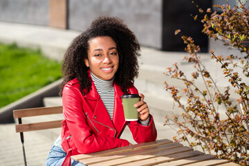 Poster - Photo of shiny cute girl dressed leather red jacket enjoying coffee modern device outdoors urban cirty street