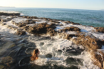 Girl in rock pool in New Zealand