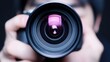 © Cdel - Camera-focused professional capturing moments, man holding camera, looking through lens, engaged in photography, exploring creative angles, showcasing artistic vision and technique.