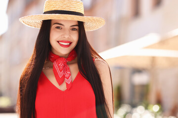 Canvas Print - Beautiful young woman in stylish hat on city street, space for text