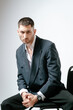© Elina Leonova - Portrait of handsome man, fashion model. Sits on chair.