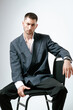 © Elina Leonova - Portrait of handsome man, fashion model. Sits on chair.