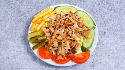 Delicious porion doner kebab with fries and vegetables