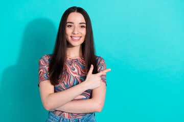 Sticker - Photo of adorable lovely girl wear striped t-shirt pointing empty space isolated teal color background