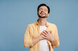 © Maria Vitkovska - Man feeling deep gratitude with hands on chest and eyes closed