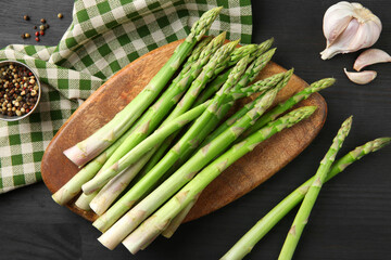 Wall Mural - Fresh green asparagus stems and spices on gray wooden table, flat lay