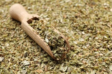 Poster - Dried oregano and wooden scoop, closeup view