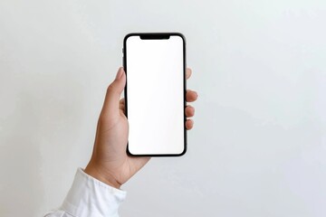 Canvas Print - A person holds a cell phone with a white screen, suitable for use in illustrations about technology, modern life, or communication