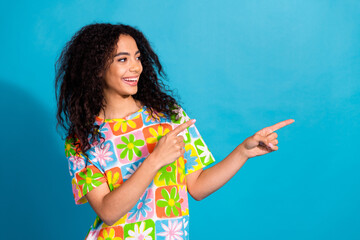 Poster - Photo of charming positive girl wear flower print t-shirt showing two fingers empty space isolated blue color background