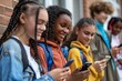 © Yevhen - Group of joyful teenagers happily using their mobile phones at a lively high school setting