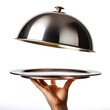 © Anomal - Hand holding Silver serving cloche raised above empty golden plate, cut out
