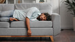 © YURII MASLAK - Tired Indian boy slumps on couch feeling listless. Feeling depressed, lack of motivation, sadness, boredom. Exhausted, he collapses on the couch from stress. Burn out.