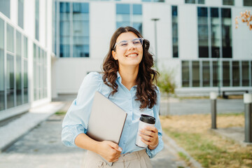 Young successful woman is going to work at modern business building	