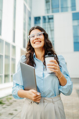 Young successful woman is going to work at modern business building	