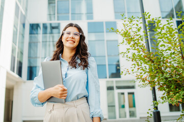 Young successful woman is going to work at modern business building	