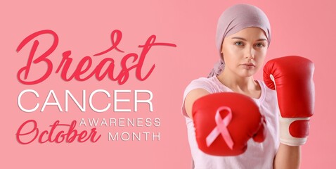 Wall Mural - Young woman after chemotherapy in boxing gloves and with pink ribbon on color background. Banner for Breast Cancer Awareness Month