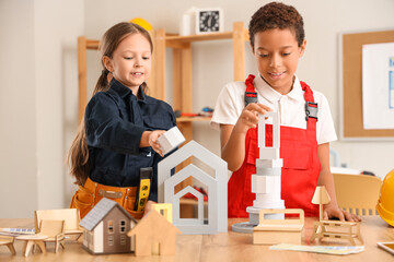 Canvas Print - Cute little architects building houses with figures at home