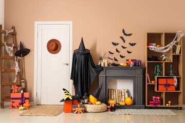 Interior of festive living room with fireplace, Halloween decorations and gift boxes