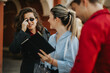 © qunica.com - Young business associates discussing plans in an outdoor setting, engaged in a casual and friendly meeting. Collaboration and teamwork in a professional environment.