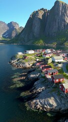 Wall Mural - Experience the stunning aerial view of Reine, a picturesque fishing village in Norways Lofoten Islands, surrounded by majestic mountains and clear waters, showcasing natures beauty