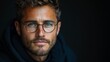 © Рудой Максим - Portrait of a young man with glasses in a dark setting, showcasing thoughtful expression and stylish appearance